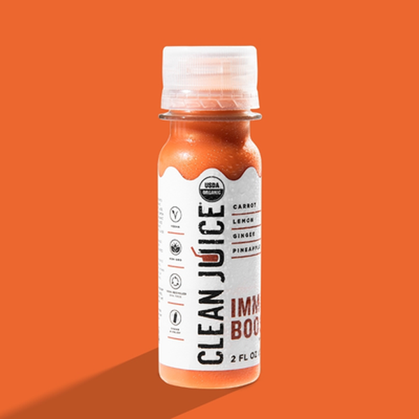 Clean Juice Immune Booster 2 oz shot bottle on an orange background