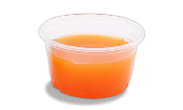 Small clear cup of bright orange Burn and Boost One juice