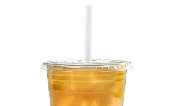 Golden apple cider juice in a lidded cup with a white straw